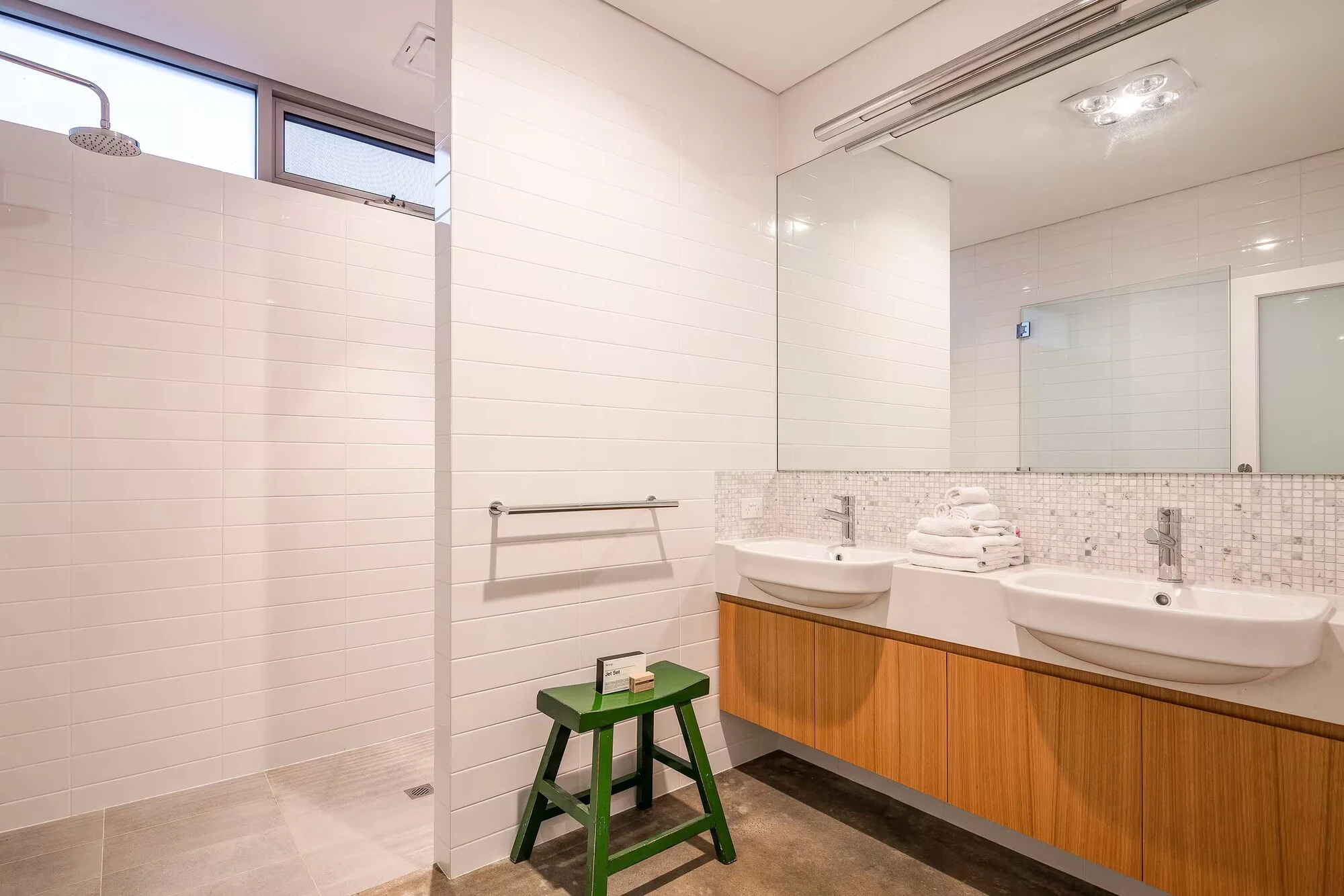 Injidup Sanctuary's bathroom with a timber double vanity, two basins and a glass-screened shower